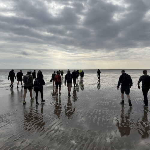People walking on a beach.